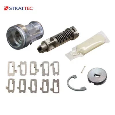 Assorted lock repair parts: metal cylinder barrel, pin tumbler core, spring, clips, gasket, screws, and a round slotted disc (StratTEC).