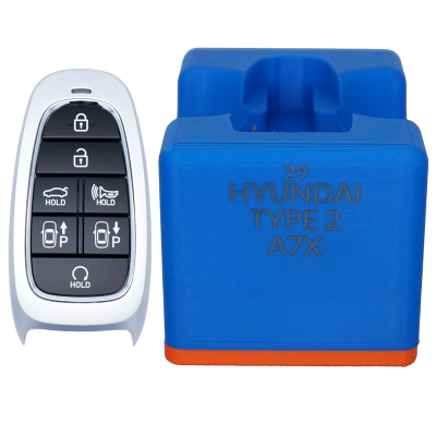 Car key fob with lock/unlock/hold buttons beside a blue Hyundai Type 2 A7X module on a white background.