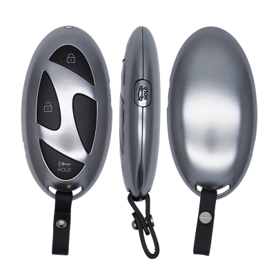 Silver oval car key fob shown from three angles: front with lock icons and 'HOLD' button, side profile, and smooth back with keychain strap.