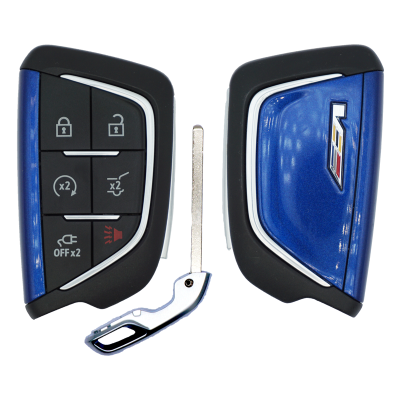Split blue Cadillac key fob halves with black button pad (lock, unlock, trunk, panic) separated by a metal blade.