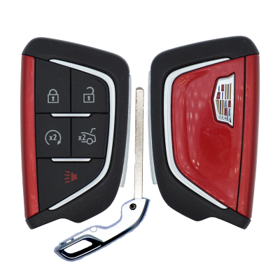 Split car key fob with Cadillac emblem; left panel has lock, unlock, trunk, and panic buttons; metal key blade sits between halves.