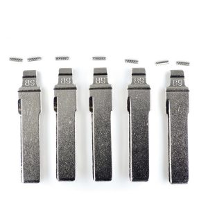 Five metal lighters standing upright in a row, their flint wheels removed and small pieces hovering above them.
